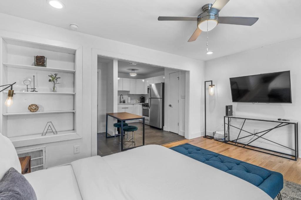a living room with a bed and a tv at Modern Midtown Stay Walk to Park & Dining in Atlanta