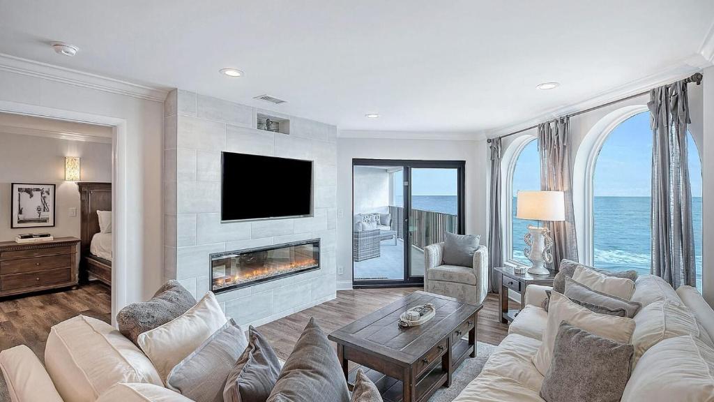 a living room with a couch and a fireplace at 412 Seascape by AvantStay Oceanfront Balcony in Isle of Palms