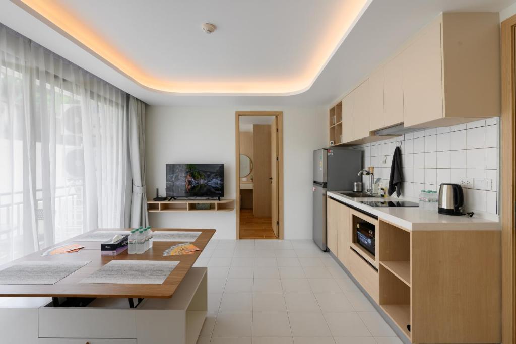 a kitchen with a table and a counter top at Kamala - 5 Min to Beach - Family Stay with 2 Baths in Kamala Beach