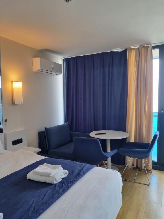 a hotel room with a bed and a table and chairs at ORBI CITY amazing holiday in Batumi