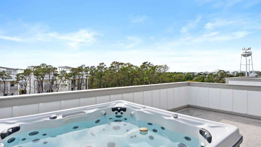 a hot tub on the roof of a balcony at Sea Dweller by AvantStay Rooftop Spa Gulf View Golf Cart Pool in Inlet Beach