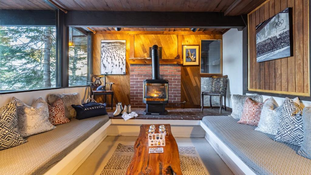 a living room with a couch and a wood stove at Mt. Jola by AvantStay A 5-minute walk away to Palisades and lifts. in Olympic Valley