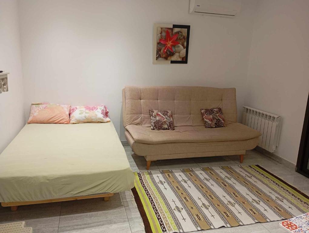 a living room with a couch and a bed at Tunisia la Goulette in Tunis