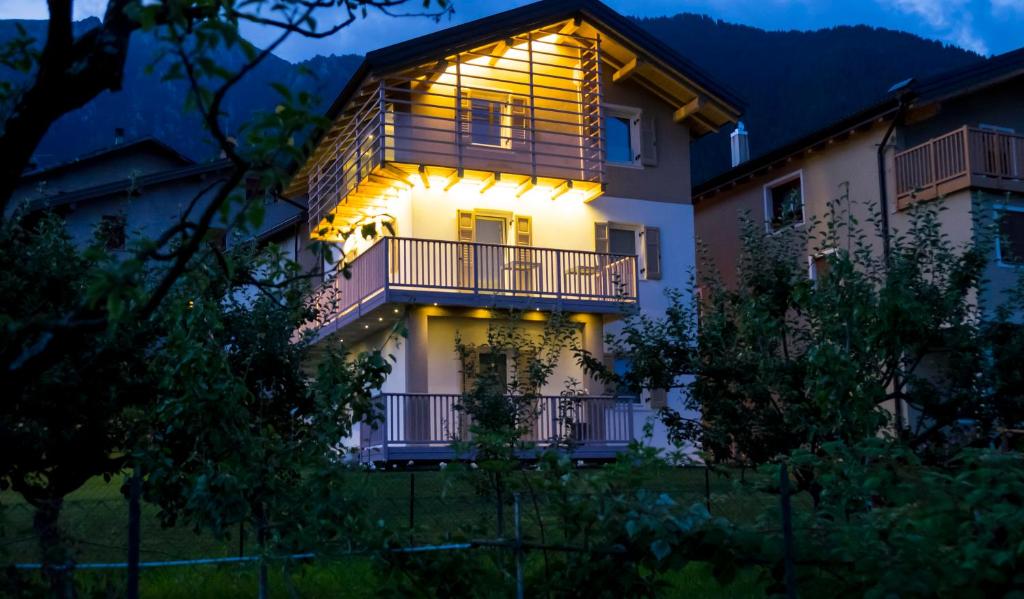 a lit up house with a balcony at night at B&B Il Piccolo Principe in Bieno