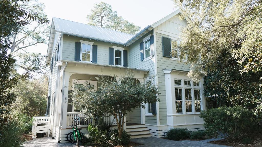 a blue house with a white at Walk to Beach 2 Shared Pools Enclosed Porch Bikes 30A Hideaway by AvantStay in Santa Rosa Beach