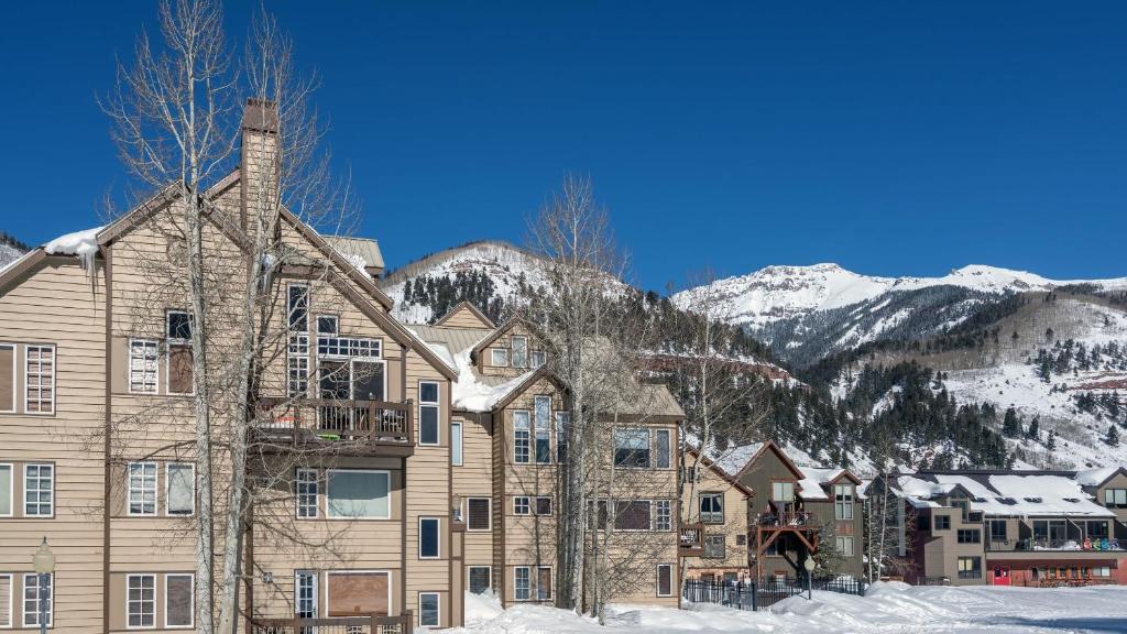 a house in the snow with mountains in the background at Etta Place Too 113 by AvantStay Close to Town The Slopes In Complex w Communal Pool Hot Tub in Telluride