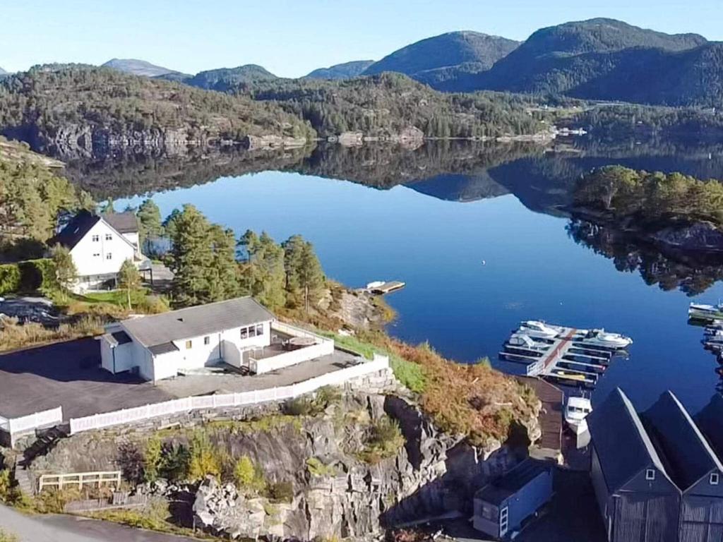 an aerial view of a lake with a house at 6 person holiday home in HOSTELAND in Hosteland