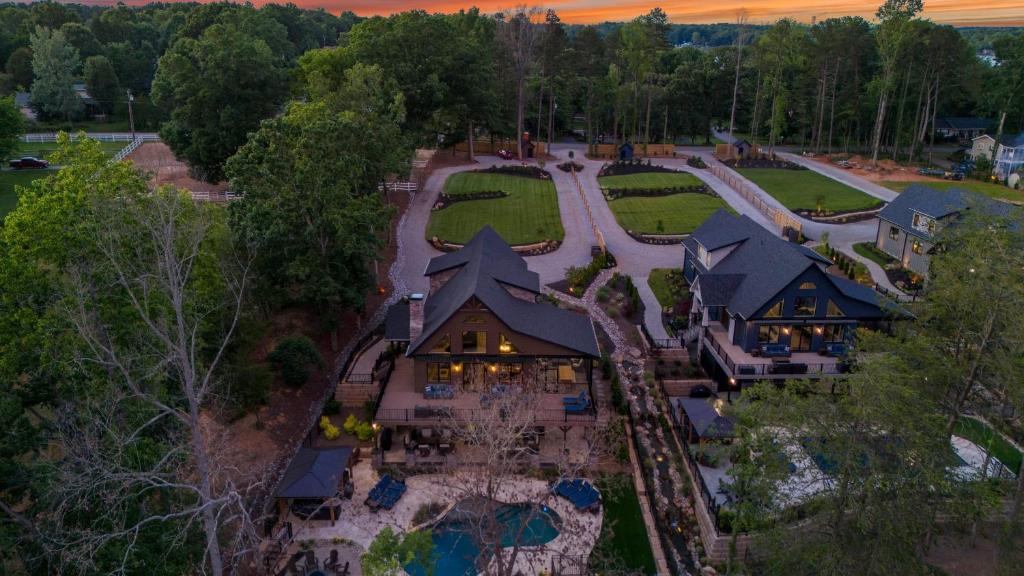 an aerial view of a house with a yard at Black Bear Blue Heron by AvantStay 2 Lakefront Homes Sleeps 43 Pool Dock Theater in Lake Norman of Catawba