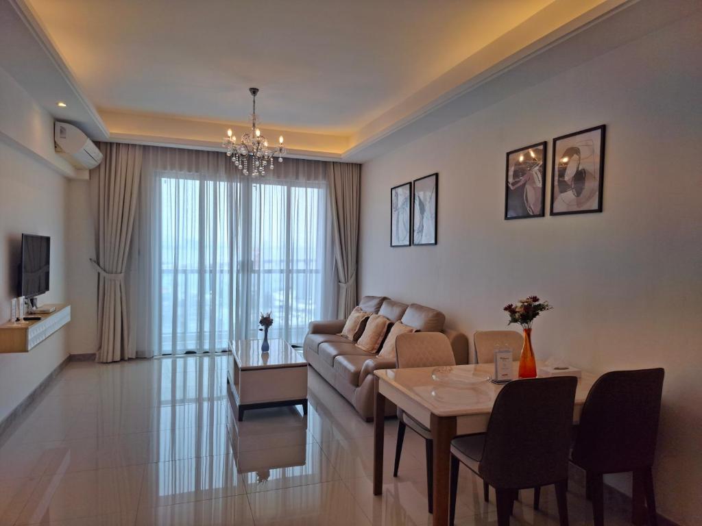 a living room with a couch and a table at R&F Princess Cove JB By SaffronCasa JB in Johor Bahru