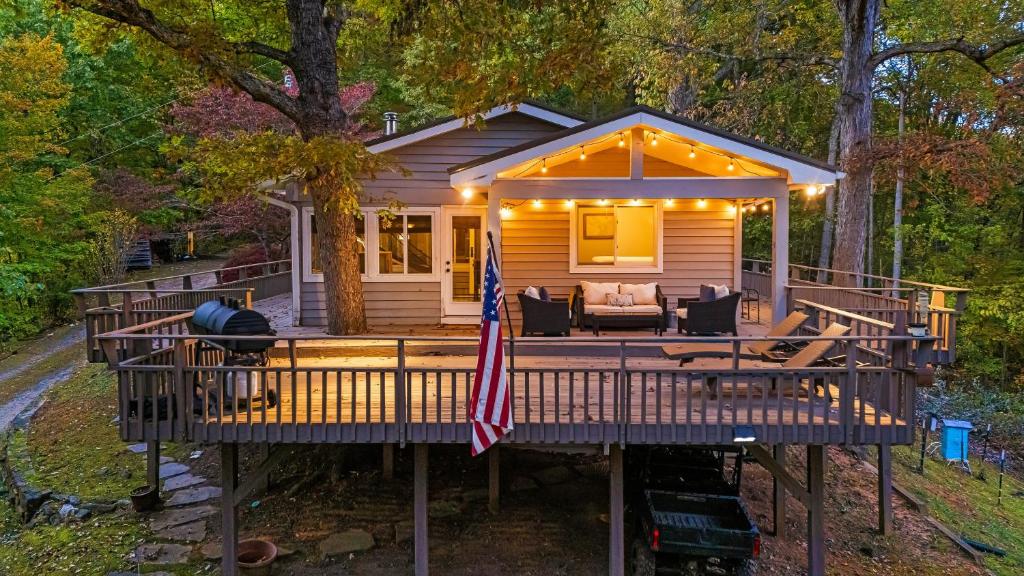 a cabin in the woods with a flag on a deck at Cabin in the Sky by AvantStay Deck w Views in Leicester