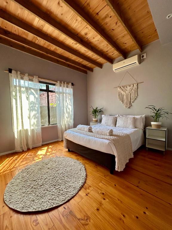 a bedroom with a large bed and a wooden ceiling at Stella Maris Cabanas in Ponta do Ouro