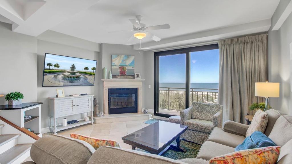 a living room with a view of the ocean at 407 A Shipwatch by AvantStay Beach Front Condo w Ocean Views in Isle of Palms