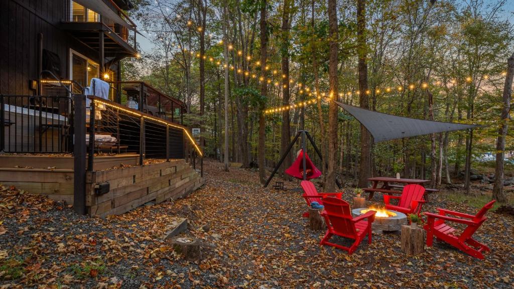 podwórko z czerwonymi krzesłami, stołem i namiotem w obiekcie Hot Tub Lake Access Community Amenities Somerset Lodge by AvantStay w mieście East Stroudsburg