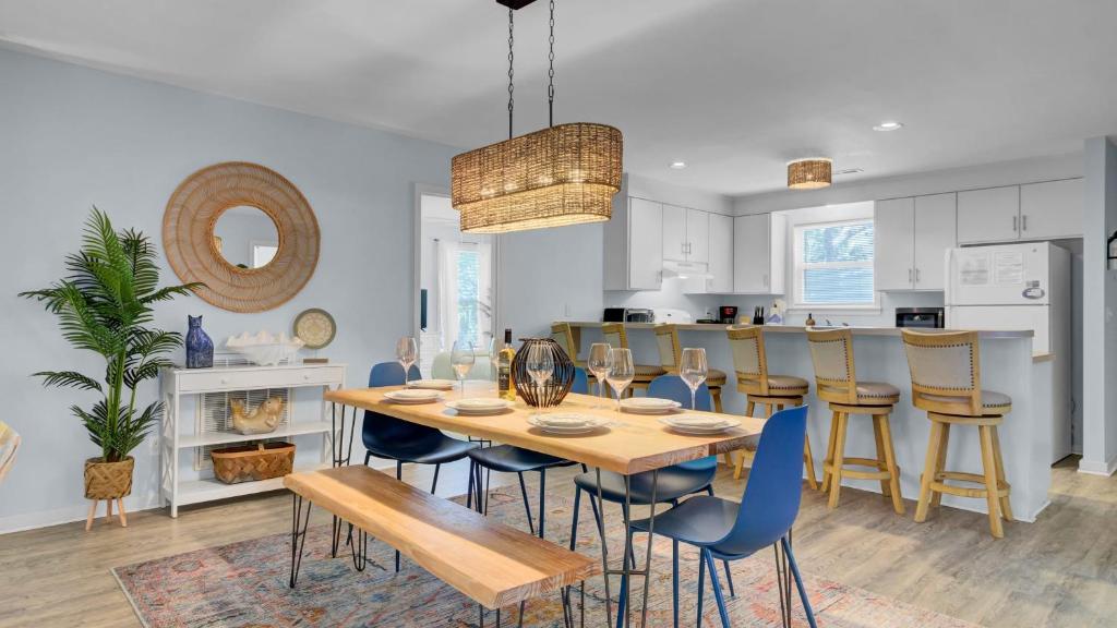 a kitchen and dining room with a table and chairs at Ion by AvantStay Walk to Beach Dining Shopping Central Location Deck in Sullivans Island