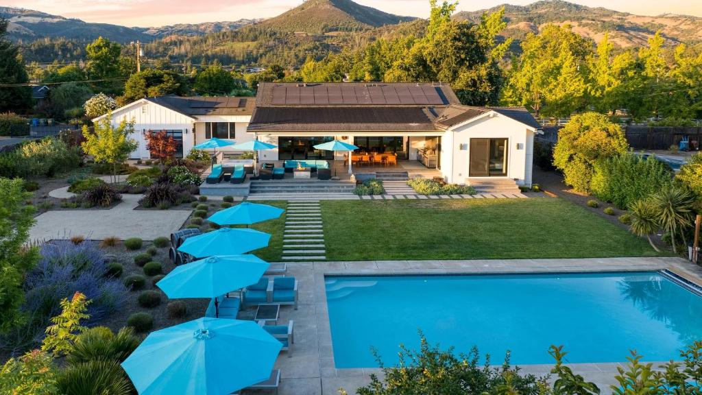 an aerial view of a home with a swimming pool and a house at Luxe Pool Spa Fire Pit Game Room Piano Sonoma Pool Retreat by AvantStay in Kenwood