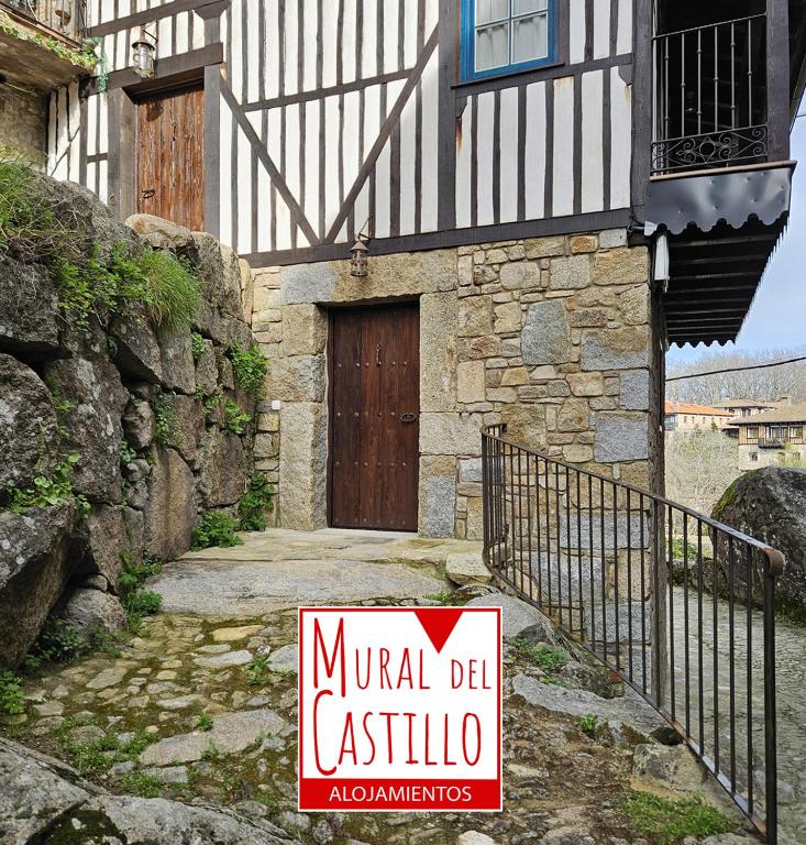 a sign in front of a building with a door at Mural del Castillo II, La Alberca in La Alberca