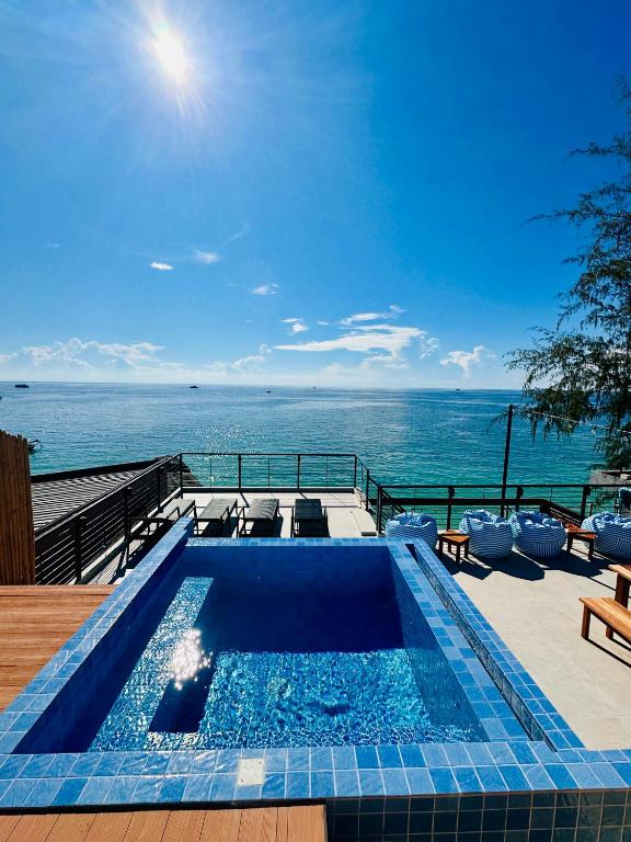a swimming pool with a view of the ocean at Sairee Beach Penthouse in Ko Tao