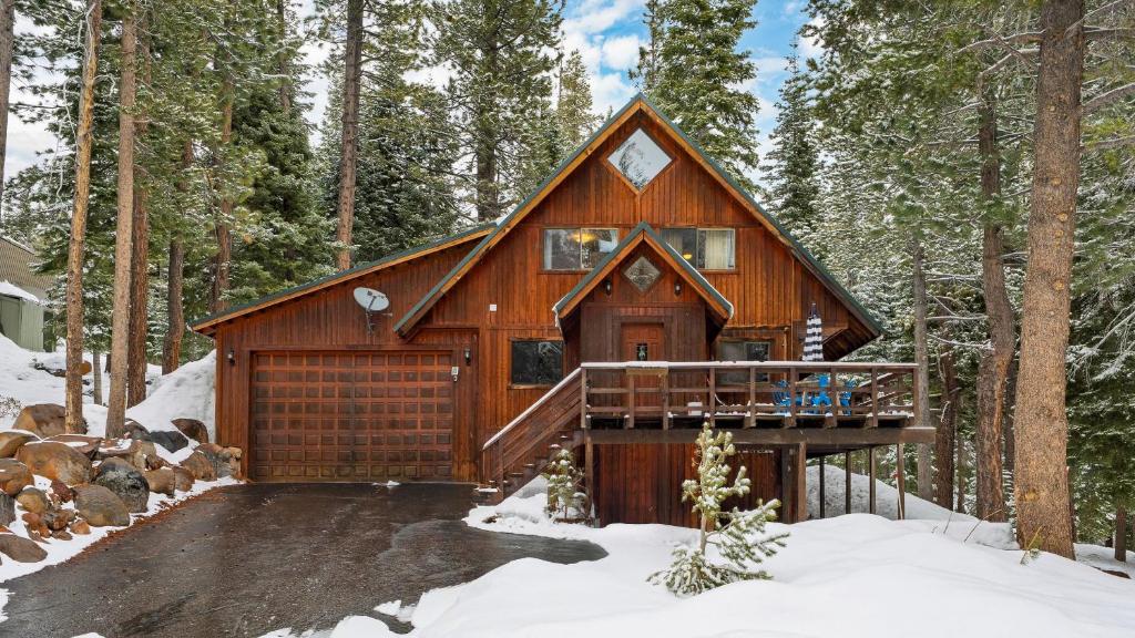 a log cabin in the woods in the snow at Private Deck Fireplace and Ski Access Near Northstar The Lazy Bear in Truckee