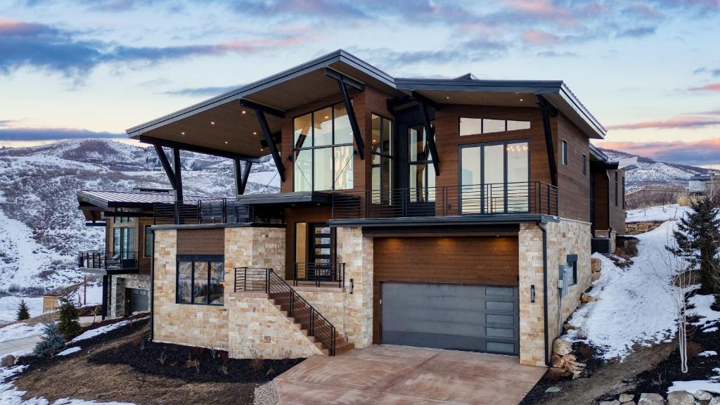 a house on a hill with a garage at Mins to Deer Valley Lift Firepit Game Room Views 5BDR Orion by AvantStay in Heber City