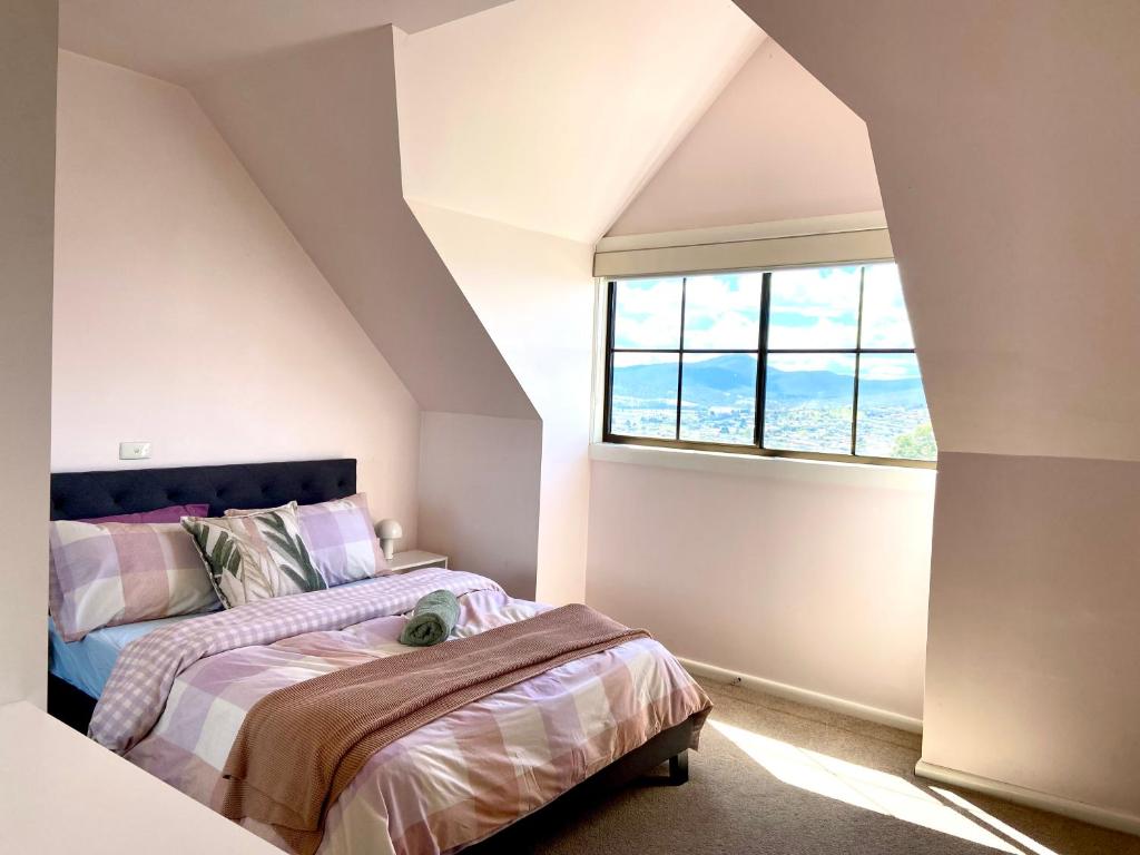 a bedroom with a bed and a window at Home in Moonah with beautiful view in Moonah