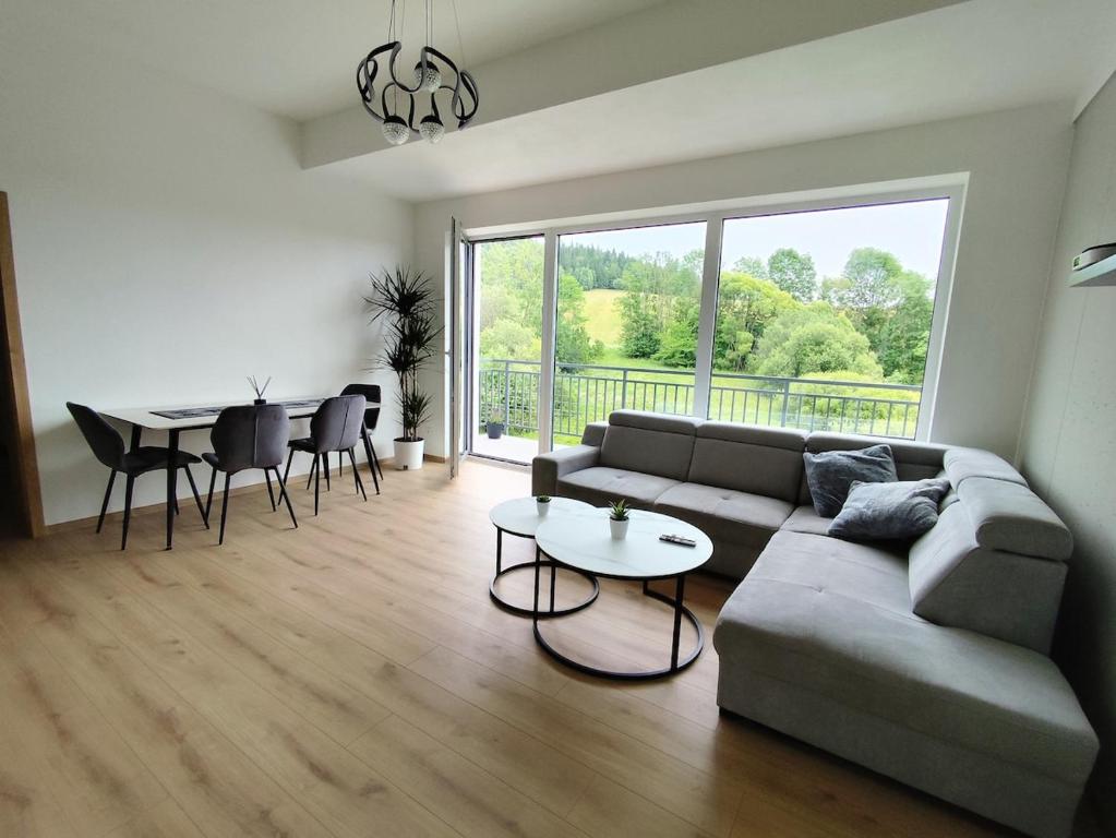 a living room with a couch and a table at Apartman Emily B311 in Veselé