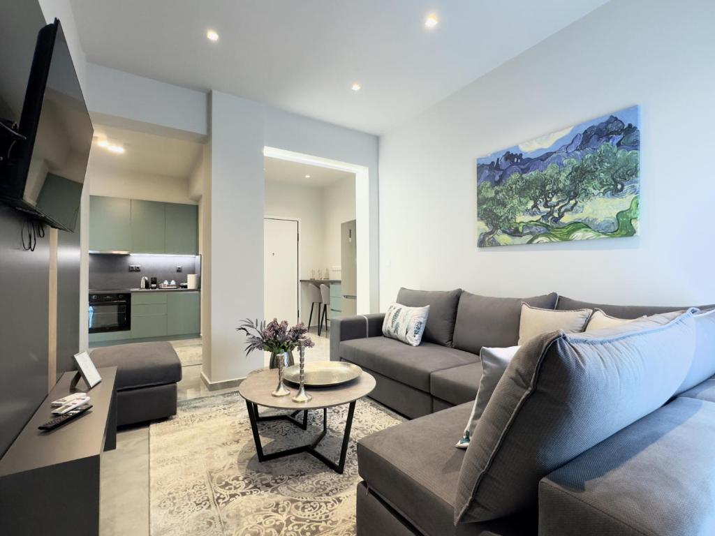 a living room with a couch and a table at City Bliss Apartments Trikala town in Tríkala