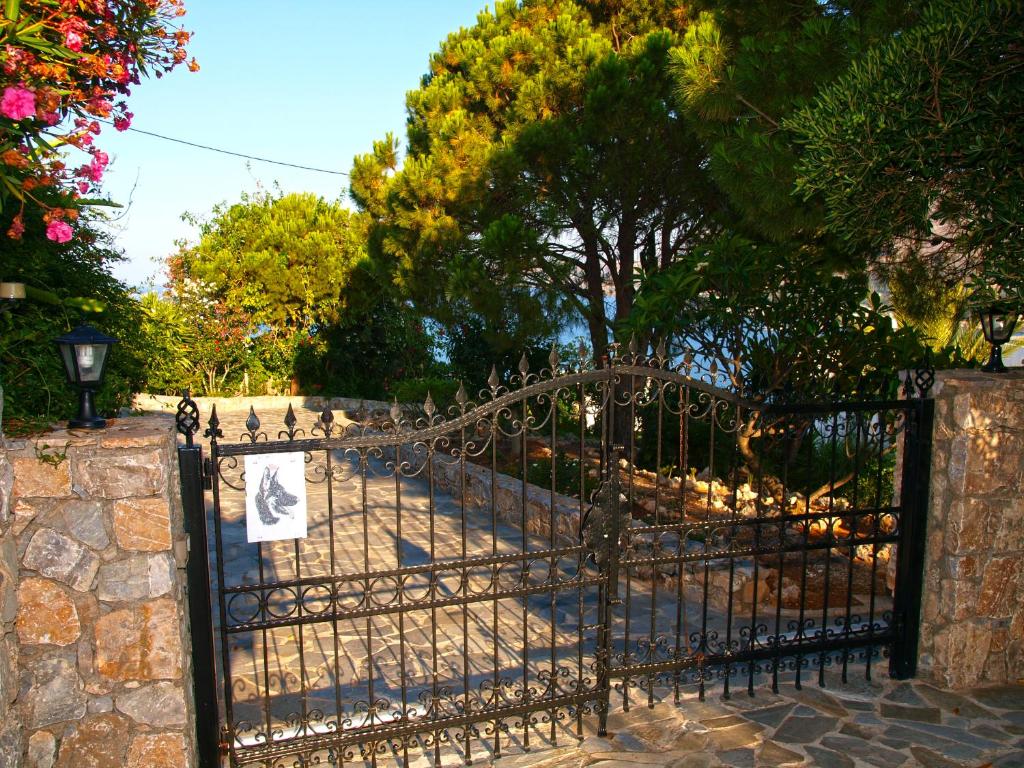 a wrought iron gate with a sign on it at Panoramic Seaview Holiday House in Souda