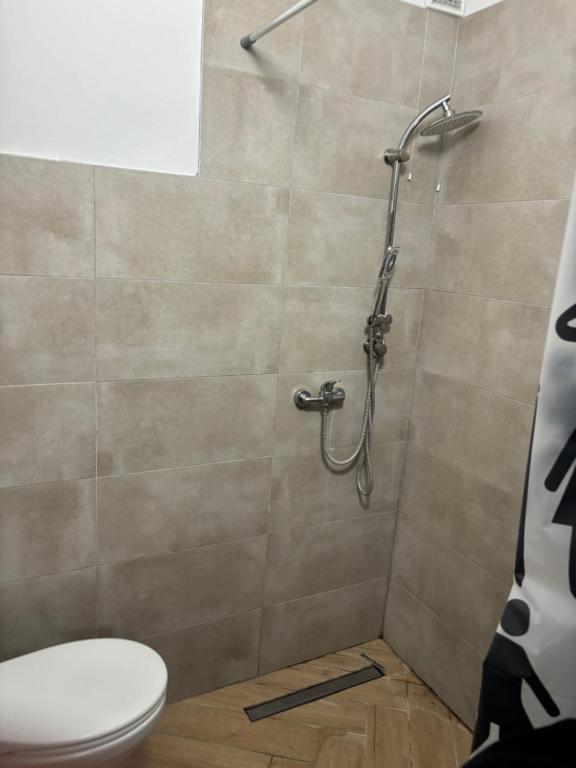 a bathroom with a shower with a toilet at Krzywa 27a apartament in Chełm