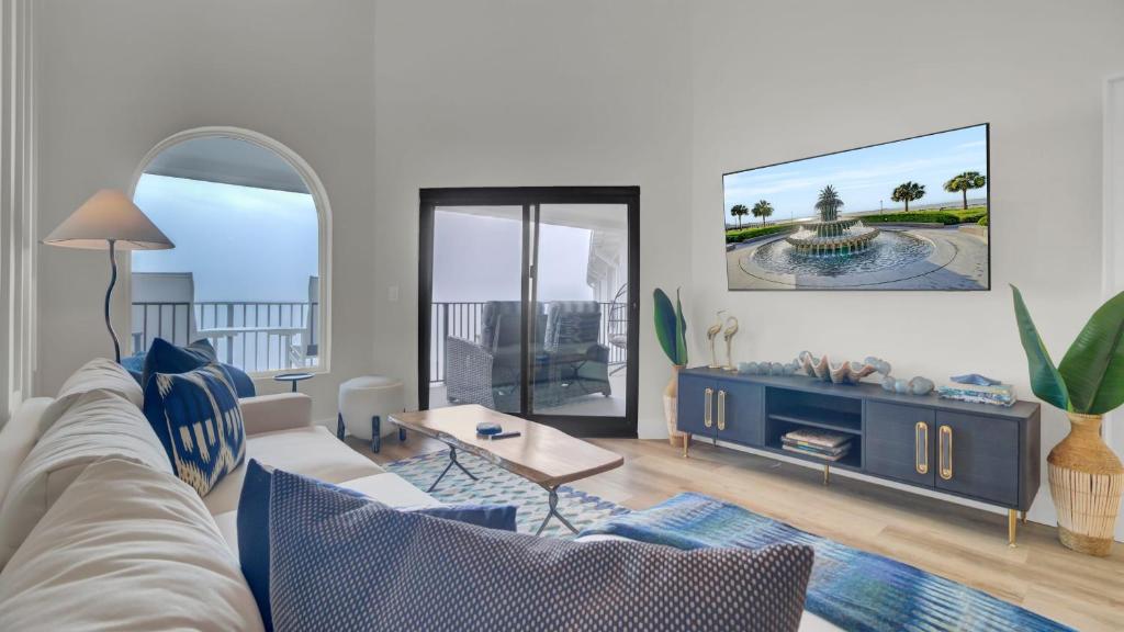 a living room with a couch and a table at 516 Seascape Oceanfront Condo with Pool Access in Wild Dunes in Isle of Palms
