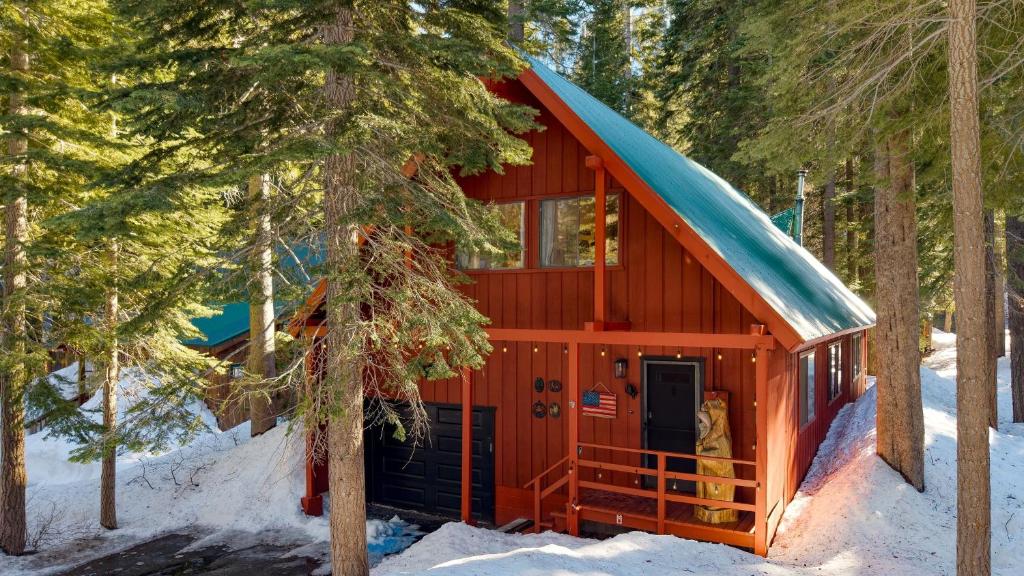 a red cabin with a blue roof in the snow at Mountain Cabin w Fireplace Balcony Easy Ski Access Bear Americana in Truckee