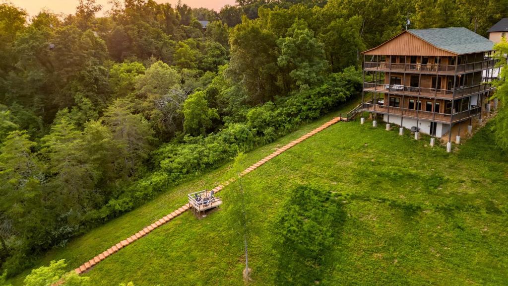an aerial view of a house on a grassy hill at Lions Landing by AvantStay Sleeps 18 Hot Tub Game Room Views Near Pigeon Forge in Sevierville