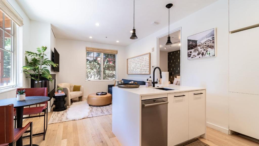 a kitchen and living room with a counter and a table at Aspen Hideaway by AvantStay Walk to Aspen Near Slopes Pool Hot Tub Access in Aspen