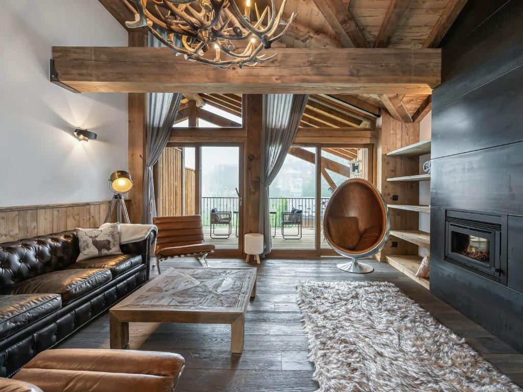 a living room with a couch and a fireplace at Duplex Charmant Près des Pistes avec Hammam et Cheminée à Courchevel Le Praz - FR-1-568-8 in Courchevel