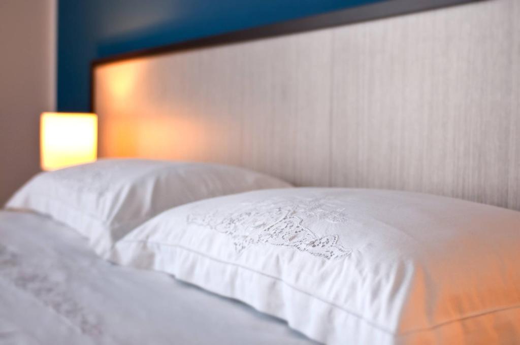 a close up of a bed with a white pillow at B&B Cous Cous People in San Vito lo Capo