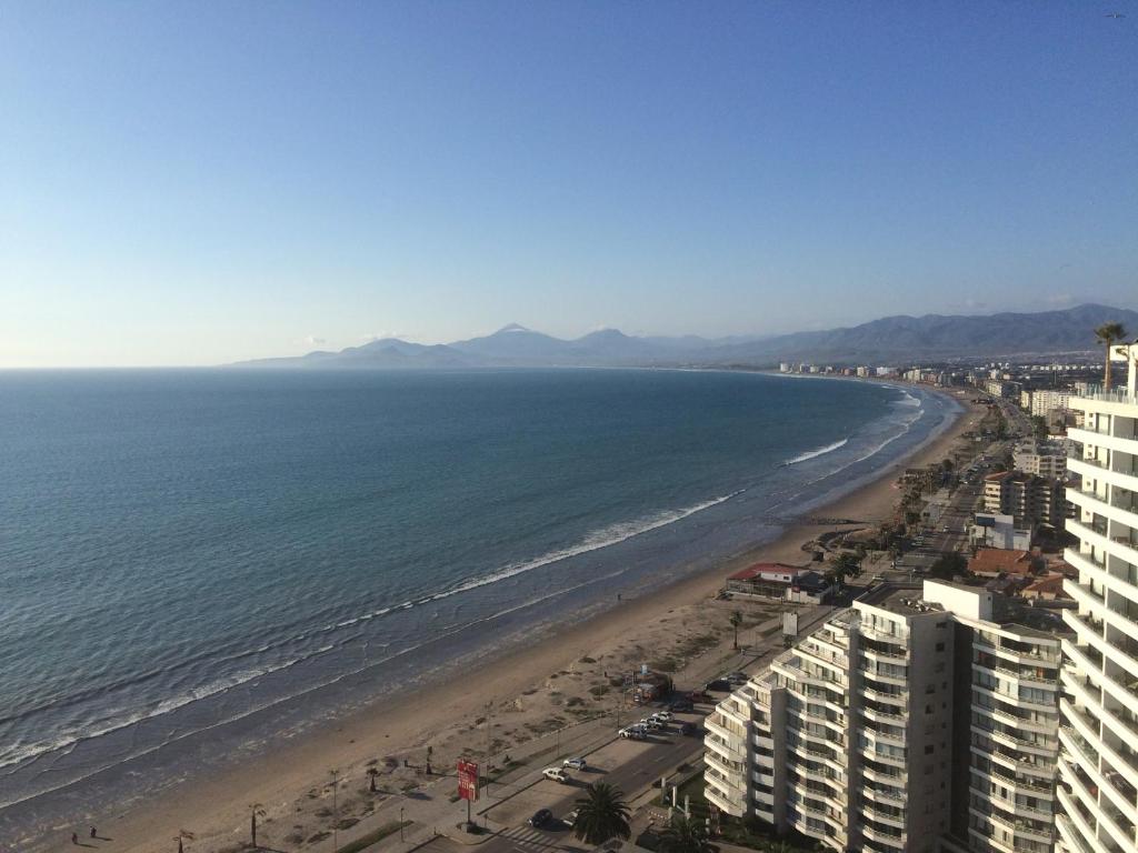 a view of a beach with buildings and the ocean at Departamentos Jardin del Mar IV Region, Chile in Coquimbo