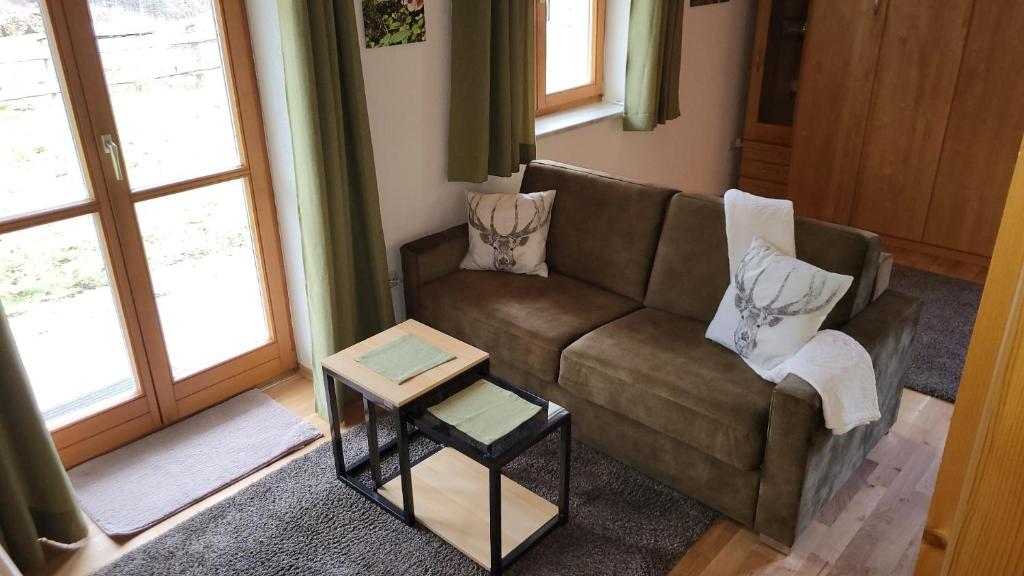 un salon avec un canapé et une table dans l'établissement Ferienwohnung Osser Woid, à Lohberg