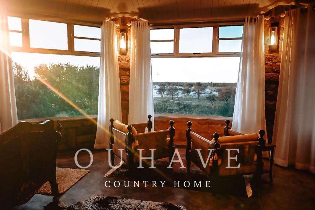 a bedroom with a bed in front of a window at Ouhave Country Home in Osire