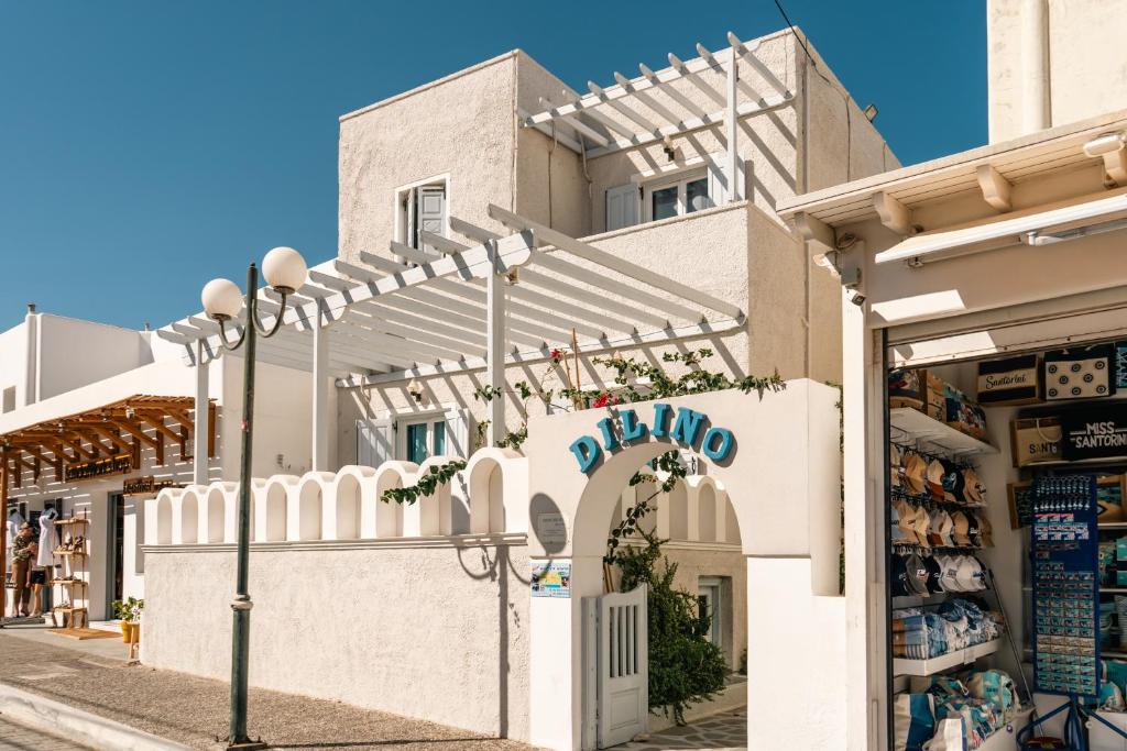 a store on a street in front of a building at Dilino in Kamari