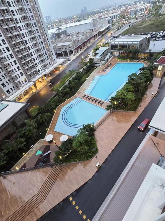 an overhead view of a swimming pool in a city at PIK2 Tokyo Riverside Apartment Studio in Muara