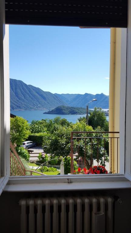 a window of a building with a view of the water at Bel Sit in Tremezzo