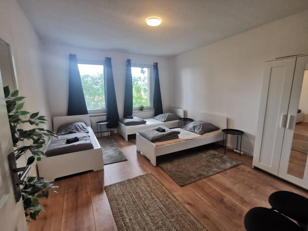 a living room with two beds and a couch at Apartmenthaus in Rüdersdorf in Rüdersdorf