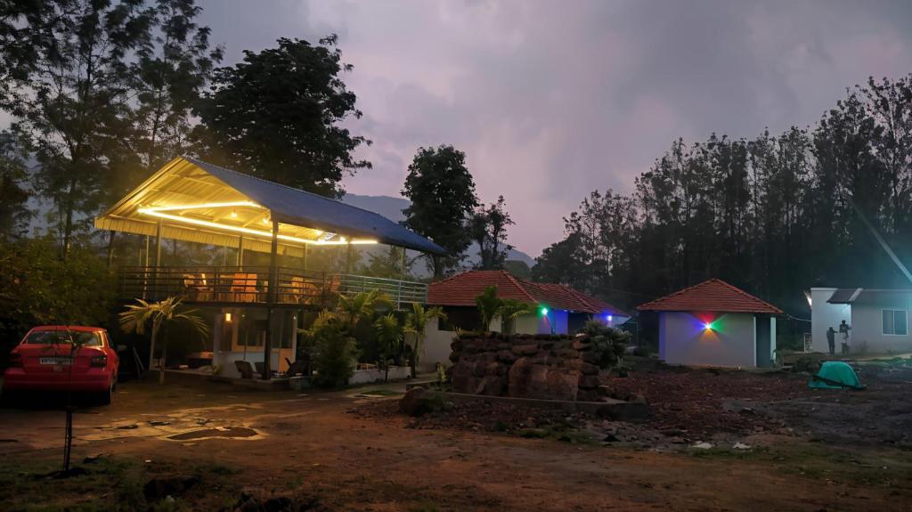 a house with a lit up roof at night at Giri Nele Homestay in Attigundi