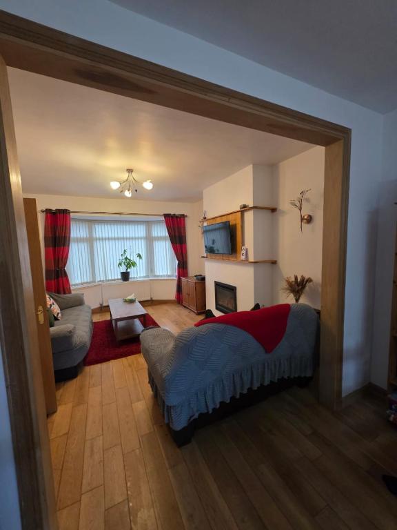 a bedroom with a bed and a living room at Orchard Serviced Accommodation in Aberdeen