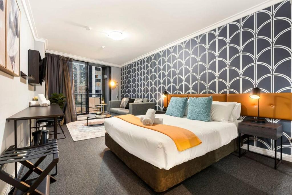 a bedroom with a large bed and a living room at KozyGuru | Haymarket | Stylish City Studio in Sydney