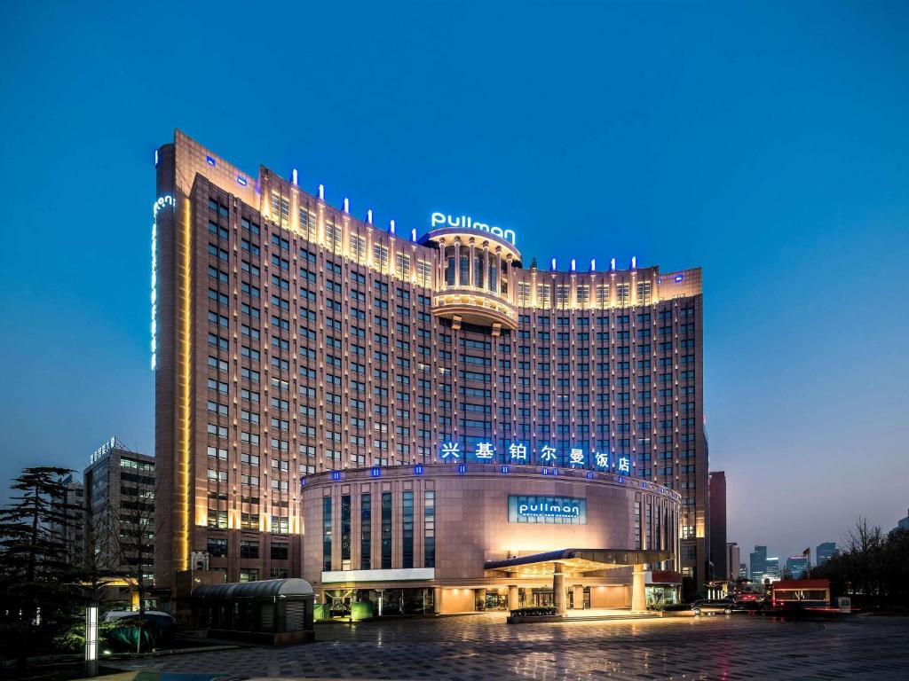a large building with a sign on top of it at Pullman Beijing South in Daxing