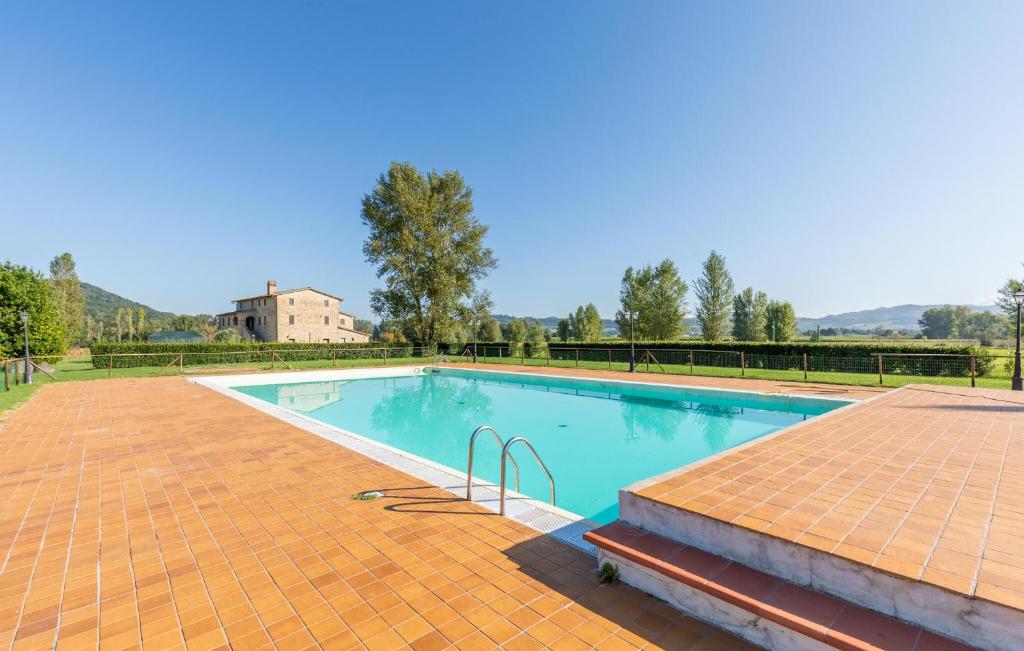 a large swimming pool with a brick floor and a brickickedicked at 1 Bedroom Awesome Apartment In Montone in Montone