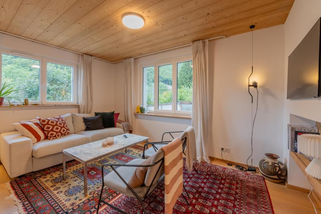 a living room with a couch and a table at Montana 101 Apartment - Snow and Trek - Montriond in Montriond