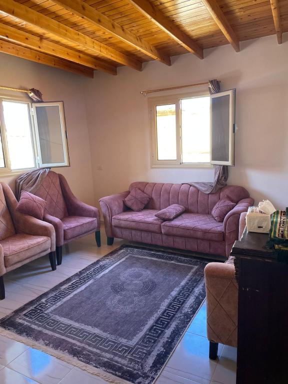 a living room with a couch and two chairs at Mountain view House in Dahab