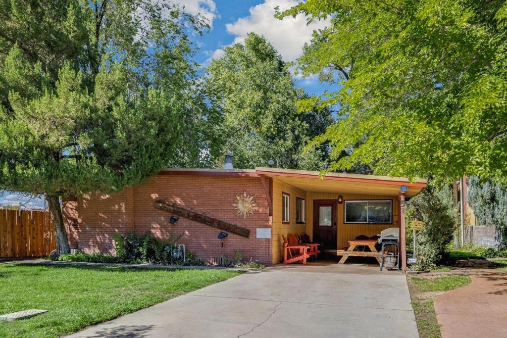 a small house with a porch and a patio at Creekside Juanita's Place - 51 E 200 in Moab