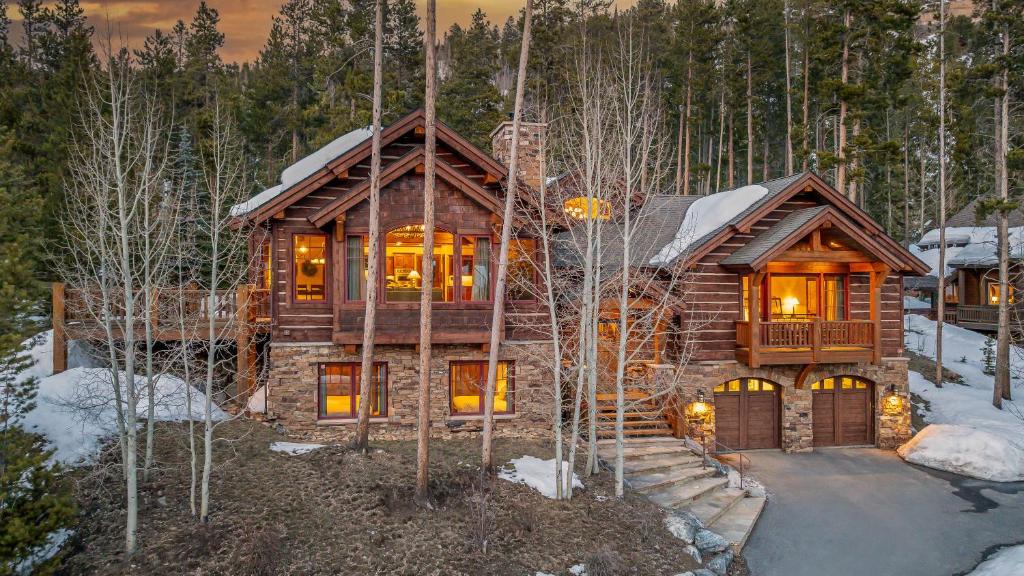 a log cabin in the woods in the snow at Rustic Timber Lodge in Breckenridge